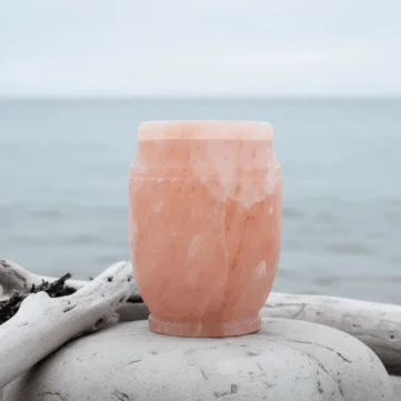 Handcrafted Himalayan rock salt urn in soft natural pink tones