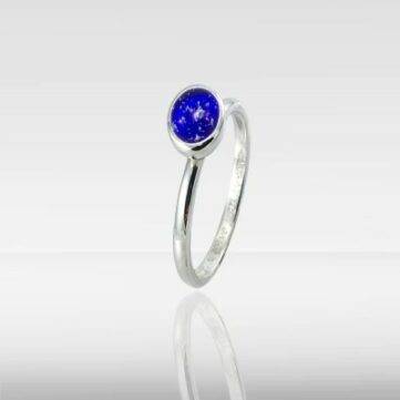 blue glass ring with ashes of a deceased loved one